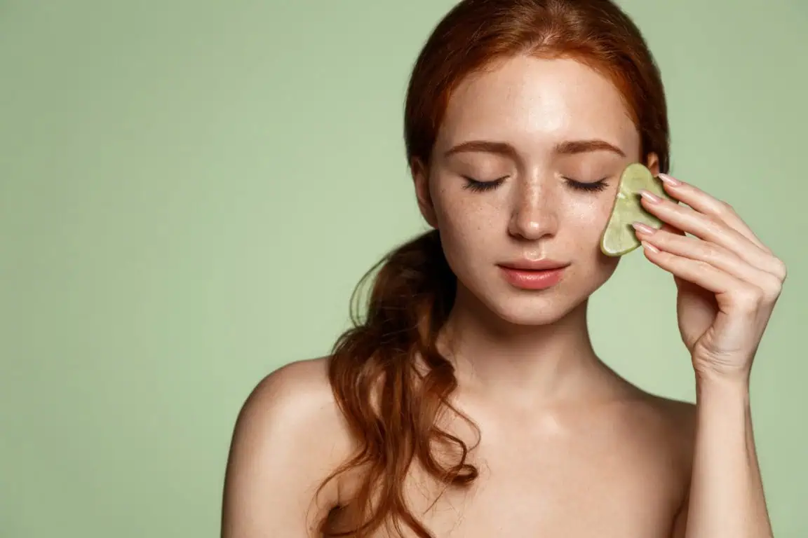 Girl giving facial massage to self