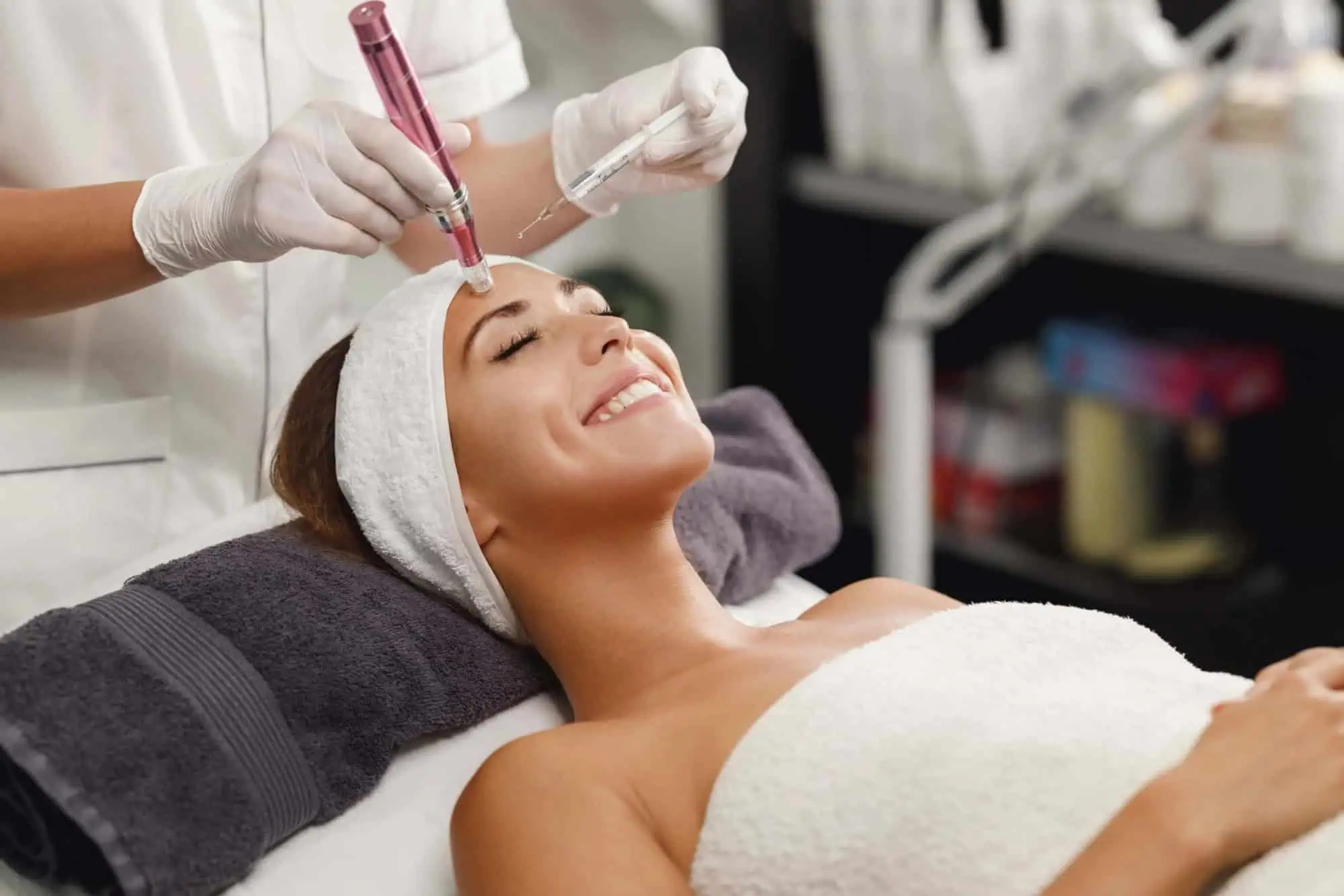 A young lady smiling and receiving dermapen treatment in santee, ca